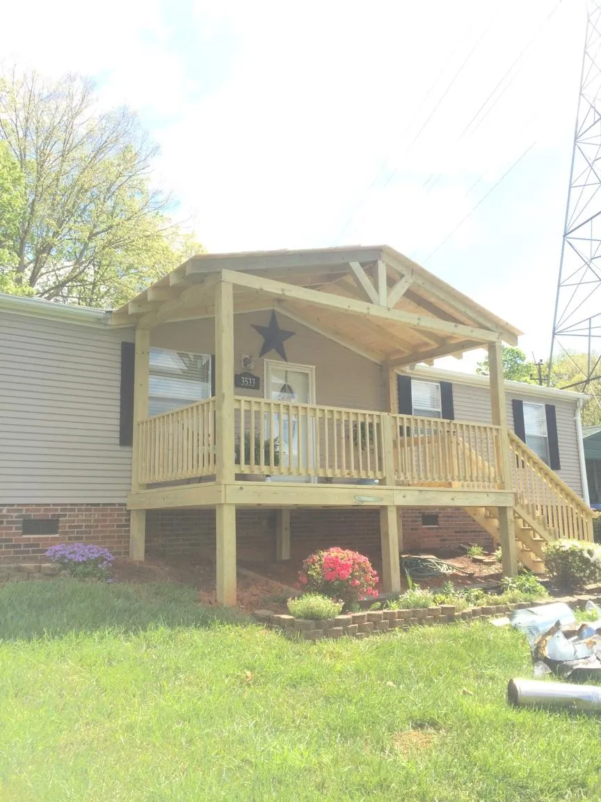 New gabled porch roof and deck railing added to a ranch home in Crystal River